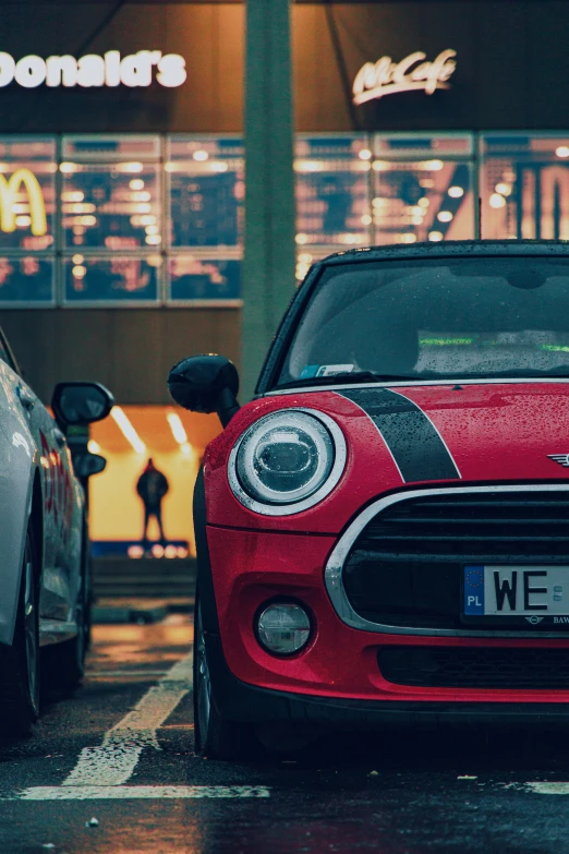 a small car with a number plate on it parked next to another car