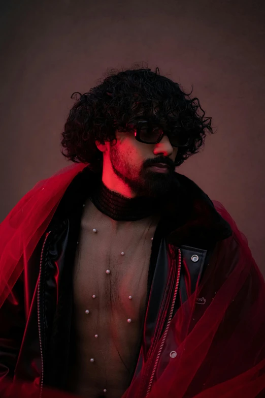 a black haired man with red sheer lining and fur coat