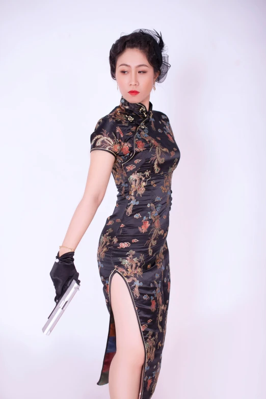 a women standing up holding a knife wearing a dress