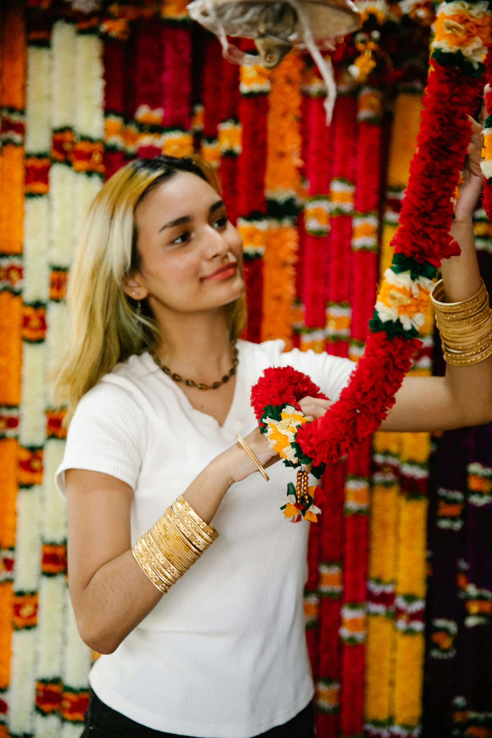 a woman holding flowers and chains with many colors