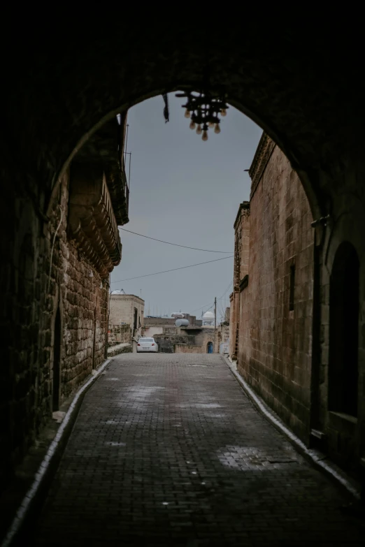 a black and white image is looking down the alley way