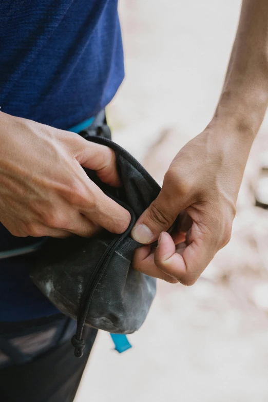 man tying up a sock for someone else to wear