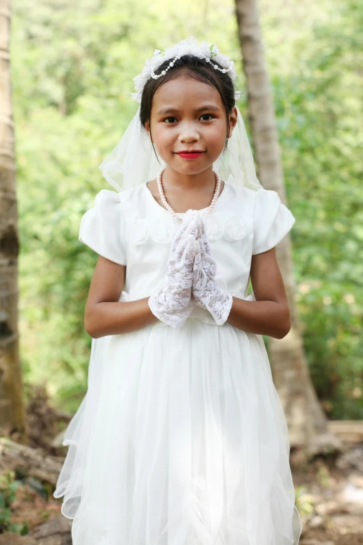 the little girl in the dress is posing for the camera