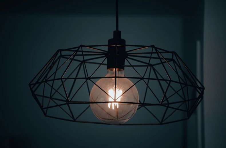 a light bulb is lit up with dark lighting