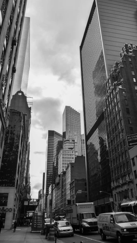 the road in a city with tall buildings near one another