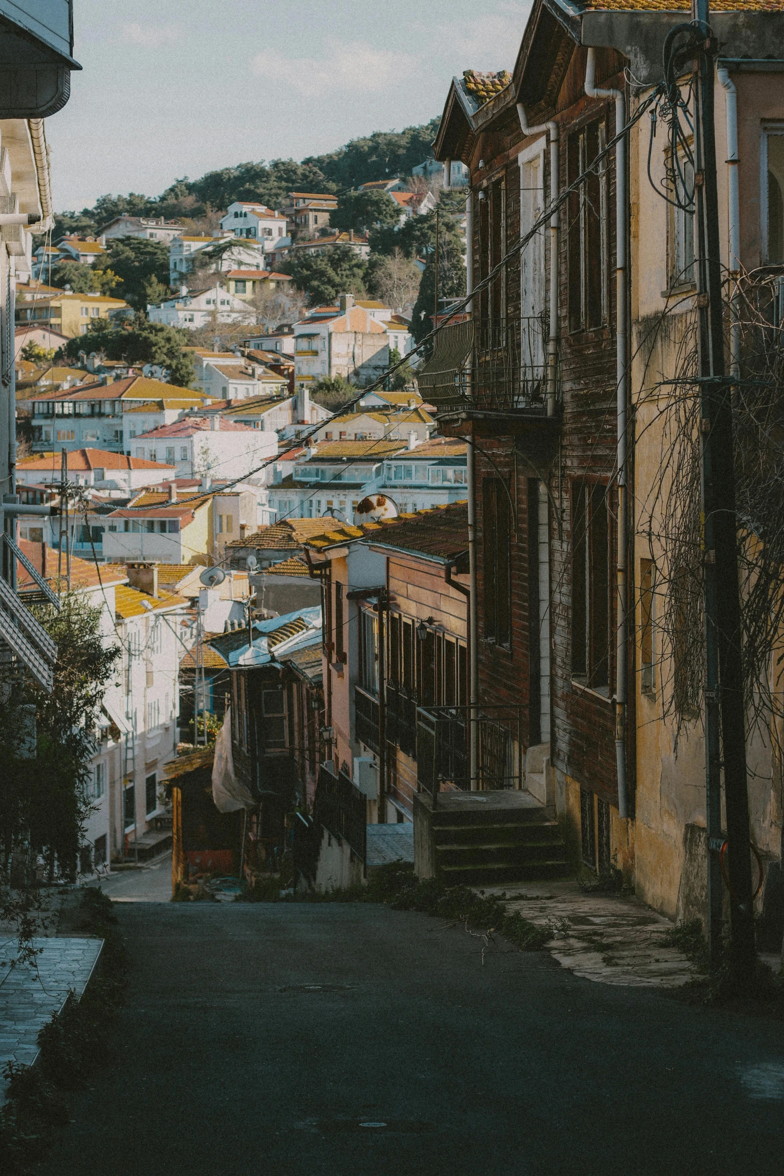 looking down an alley way into a city filled with old houses