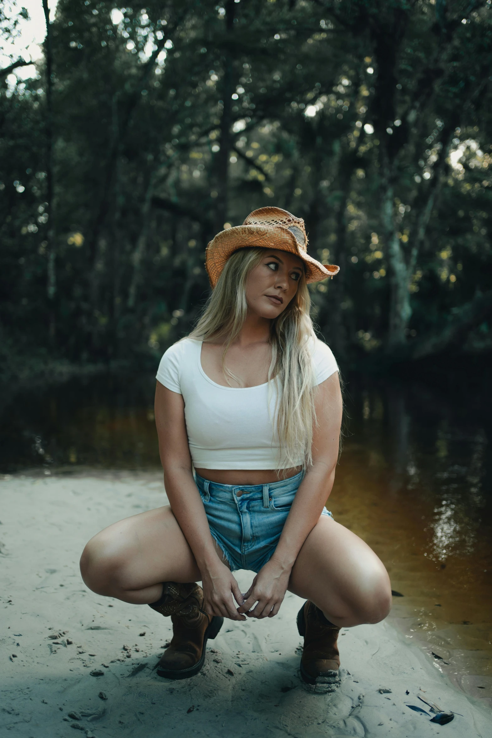 a beautiful woman in short shorts and cowboy hat