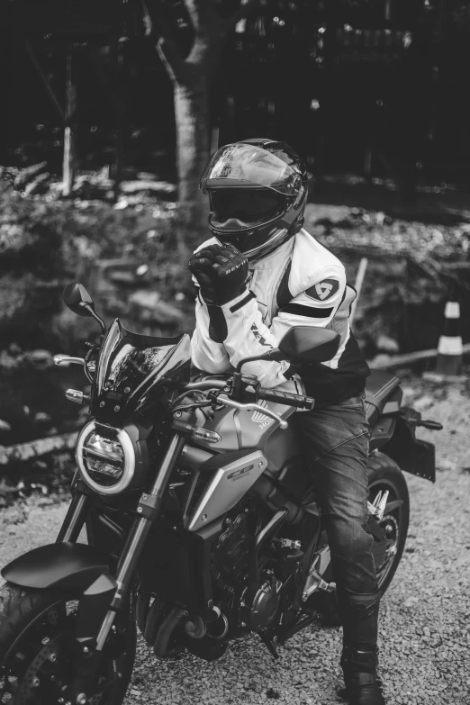 a man is sitting on a motorcycle wearing gear