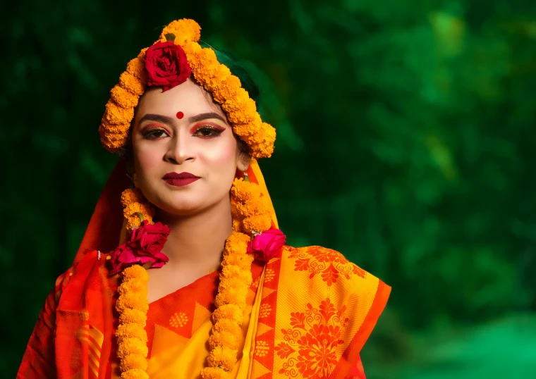 a woman with a head piece, yellow dress and orange flowers