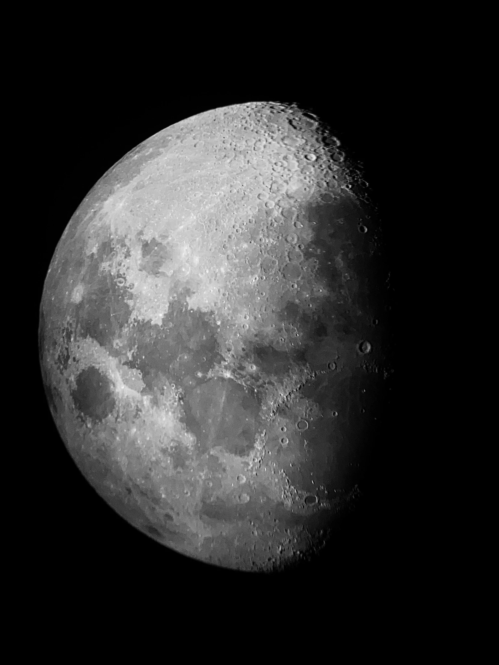 the moon in the dark sky during the day