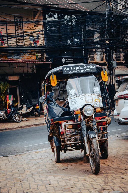 a motorcycle on a side road next to buildings