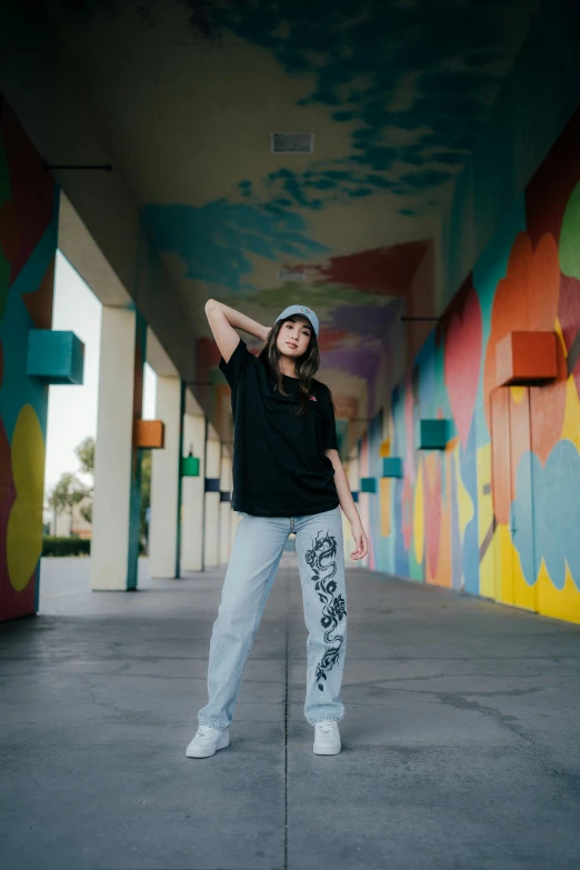 a woman posing for a po in front of colorful building