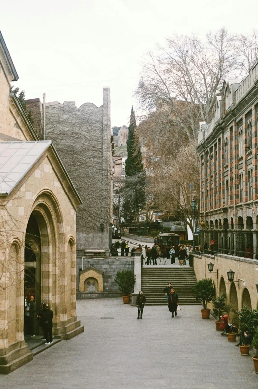 a square with stairs and potted trees