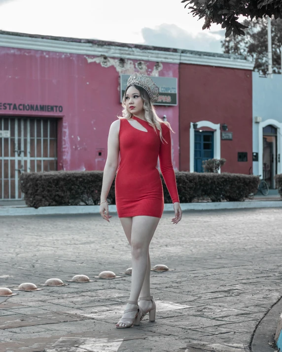 woman in a red dress walking down a street