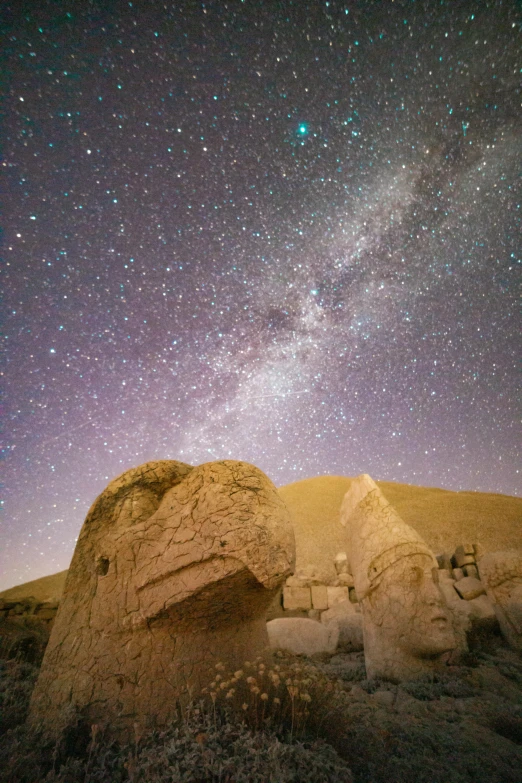 some rocks under a night sky with stars above