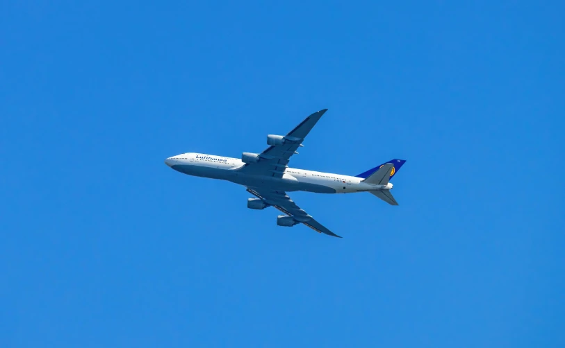 a large passenger plane flying in the blue sky