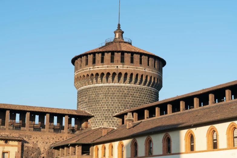 an old brick tower with round windows under a clear sky