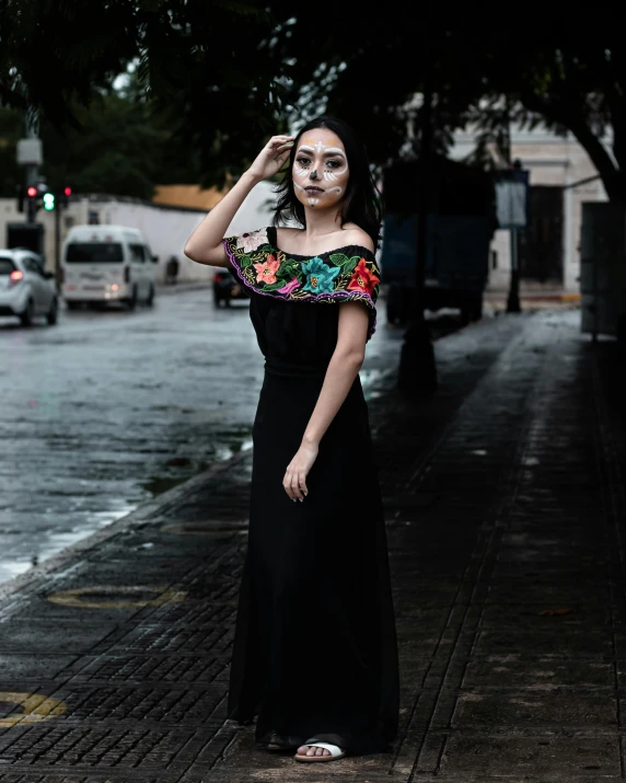 woman dressed up in a mexican style costume posing for the camera