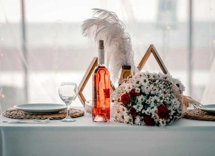 table setting with red wine and white flowers