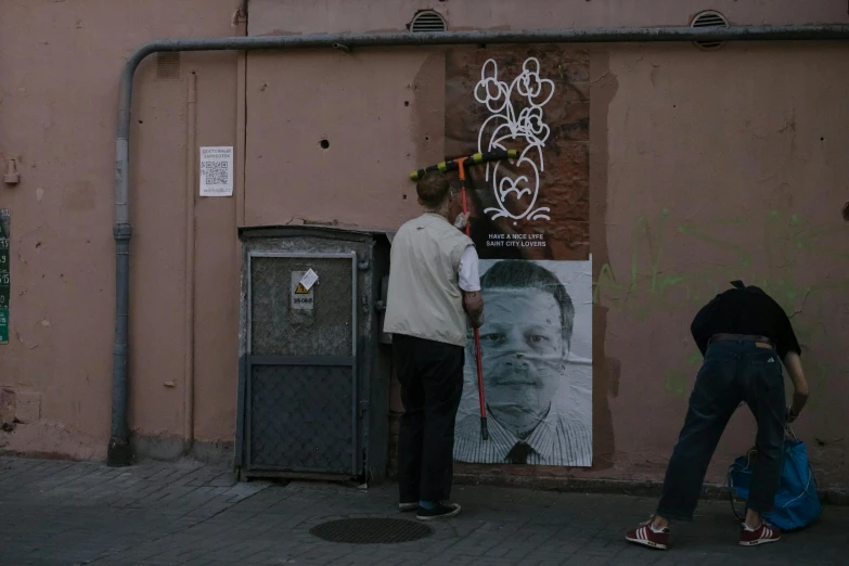 two people are standing outside next to the building