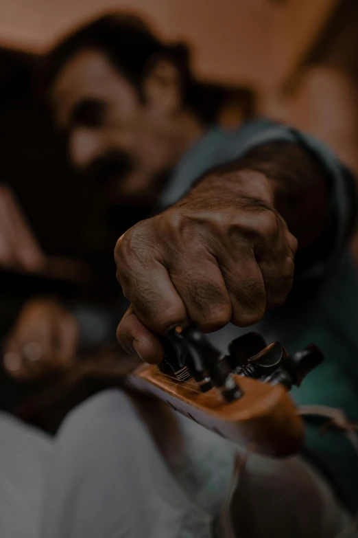 a close up of a person laying in bed with their hand on the edge of the bed