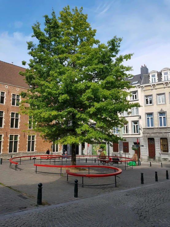 an empty park with tables around it next to trees