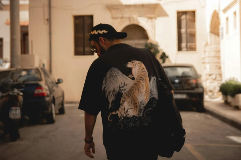 a man wearing a back pack is walking down the street