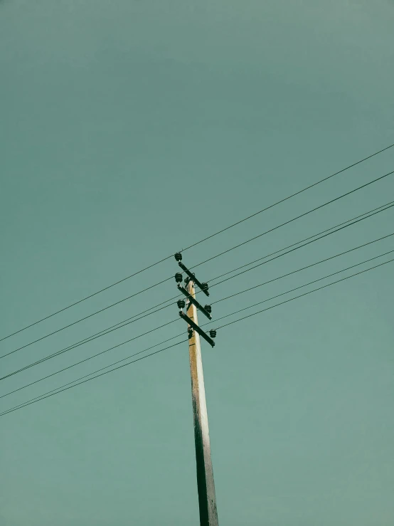 a pole that has some wires hanging from it