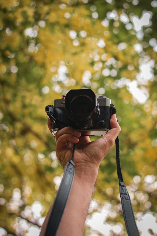 a man holding a digital camera in his hand