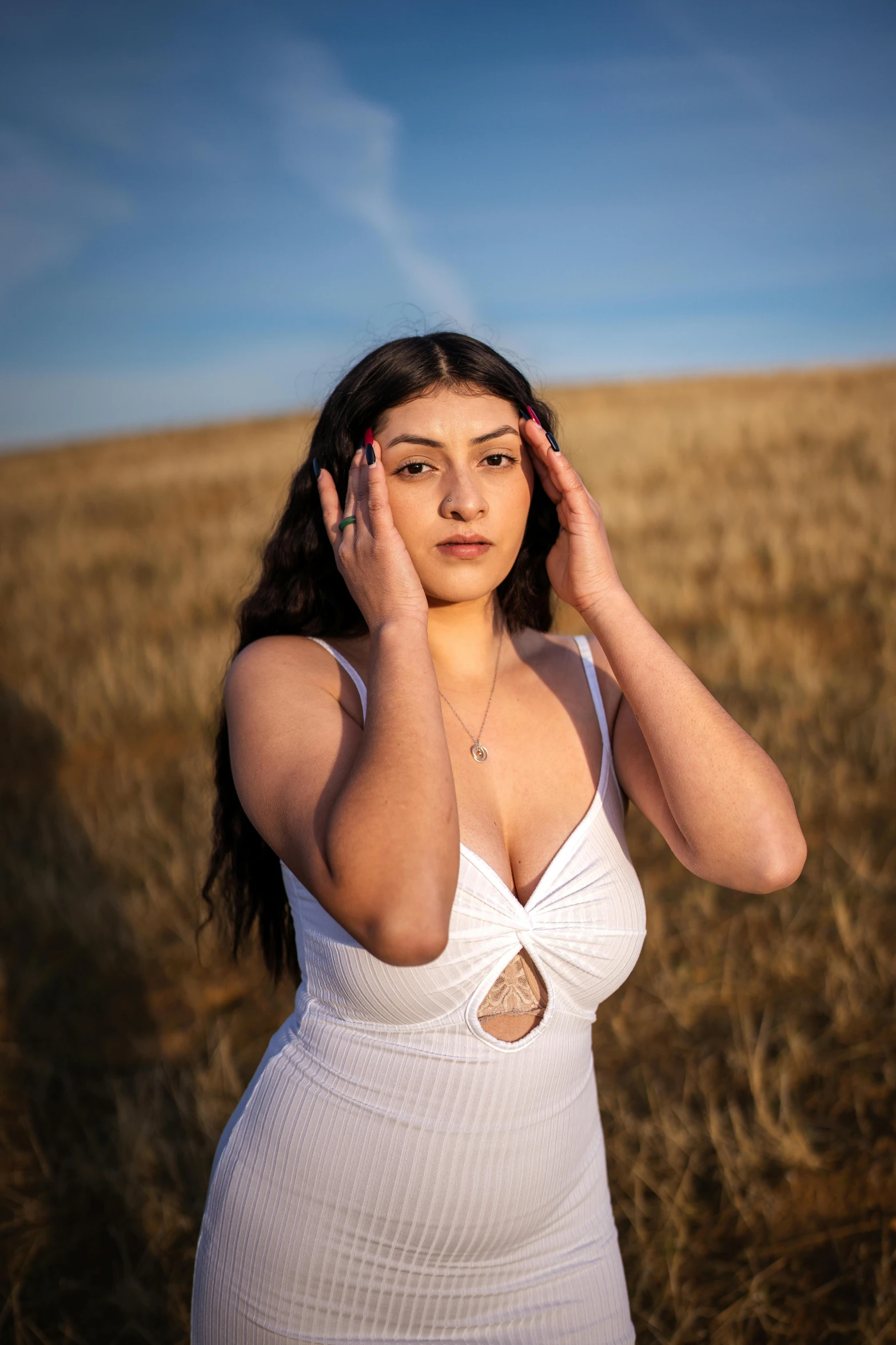 a beautiful woman in a field posing for a po