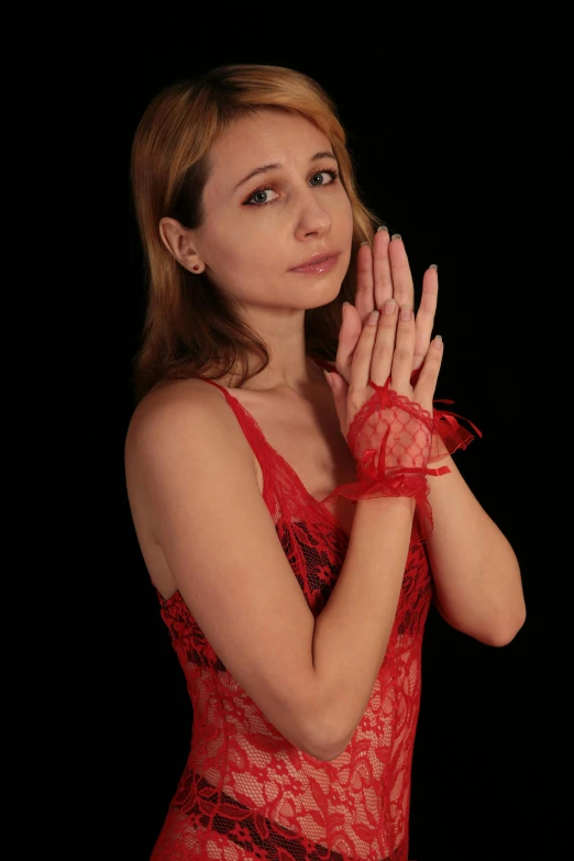 the woman with long hair is dressed in red lacy clothing