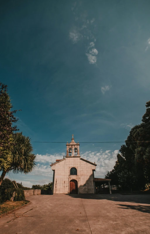 a small church with a clock tower in the middle