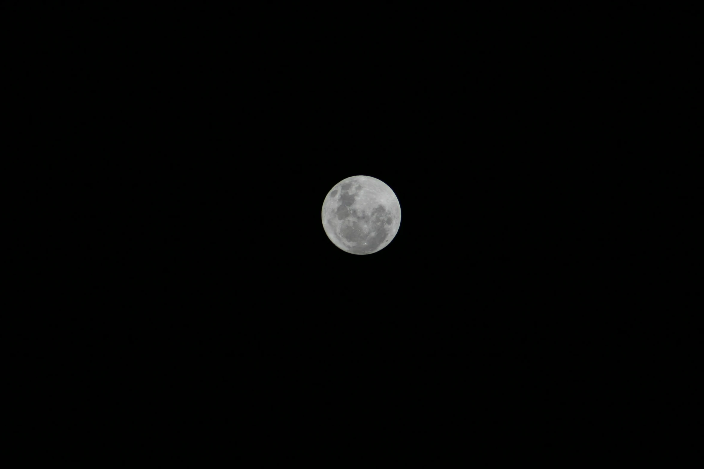 the full moon in the sky above a cloud filled night