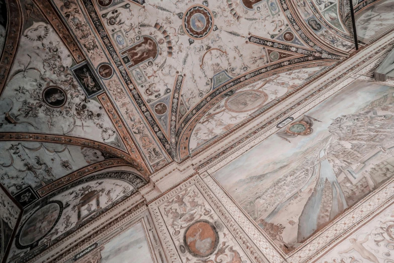 an intricate ceiling with mosaic work and windows