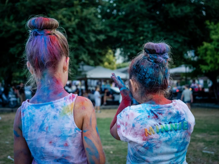 two women in the park covered in holographic paint