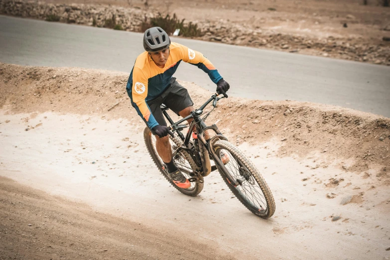 a man riding on the back of a bike in a mud dle