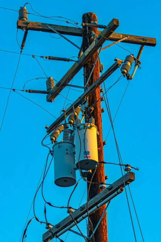 a telephone pole with multiple wires and electric lines attached to it