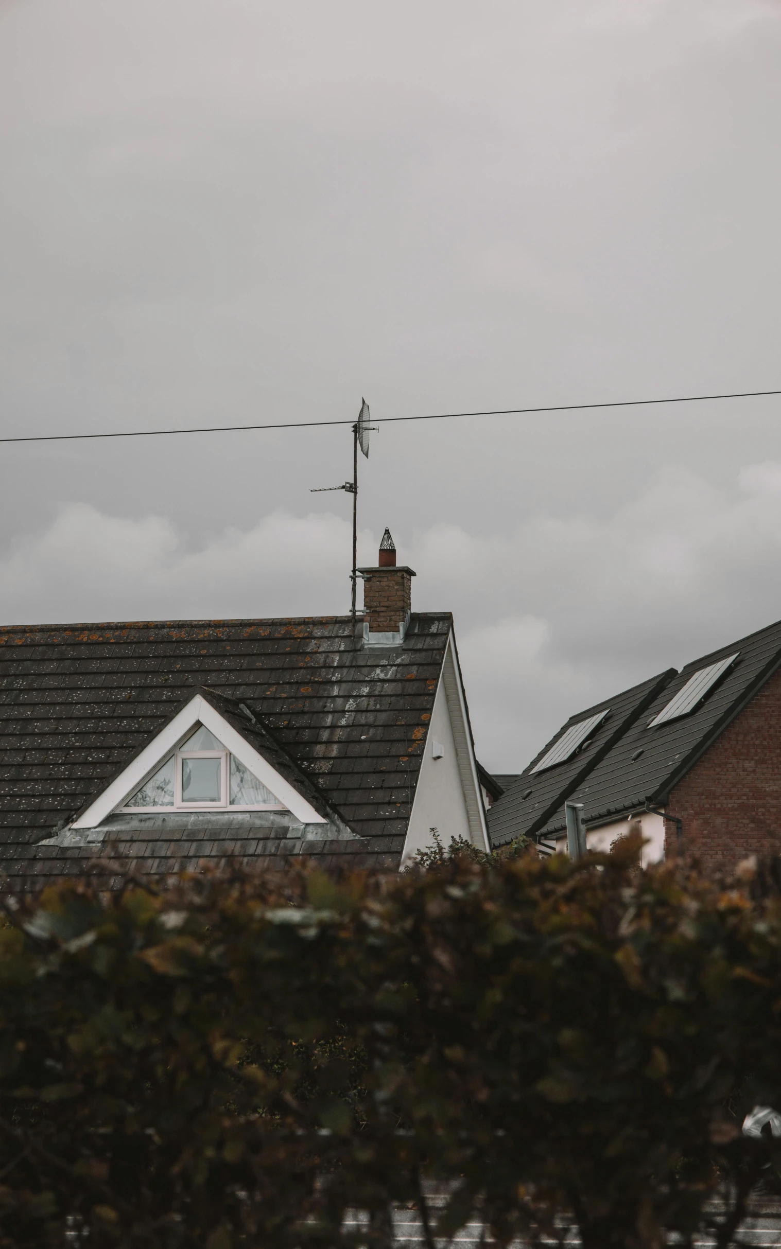 a building with a weather vane on top and sky in background