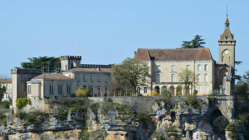 a castle sits on top of a cliff