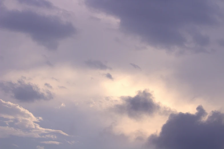 an airplane in flight against a cloudy sky