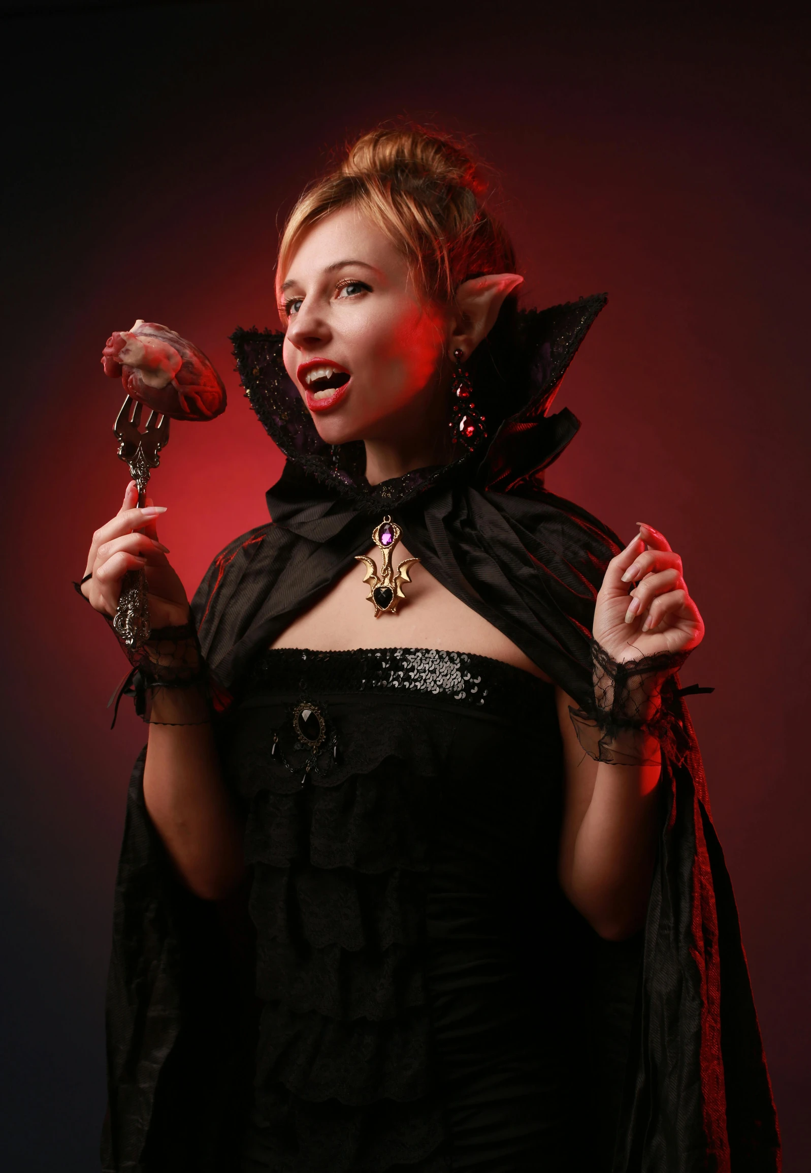 a woman in a black costume holding a doll