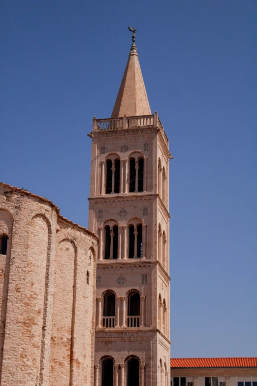 large tall white building with a tower that has two windows on each side