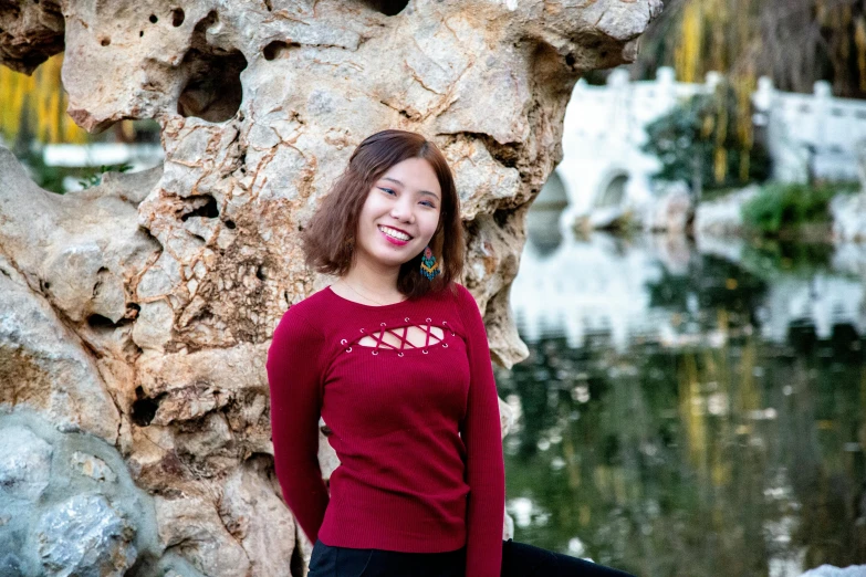 a woman standing in front of a rock face