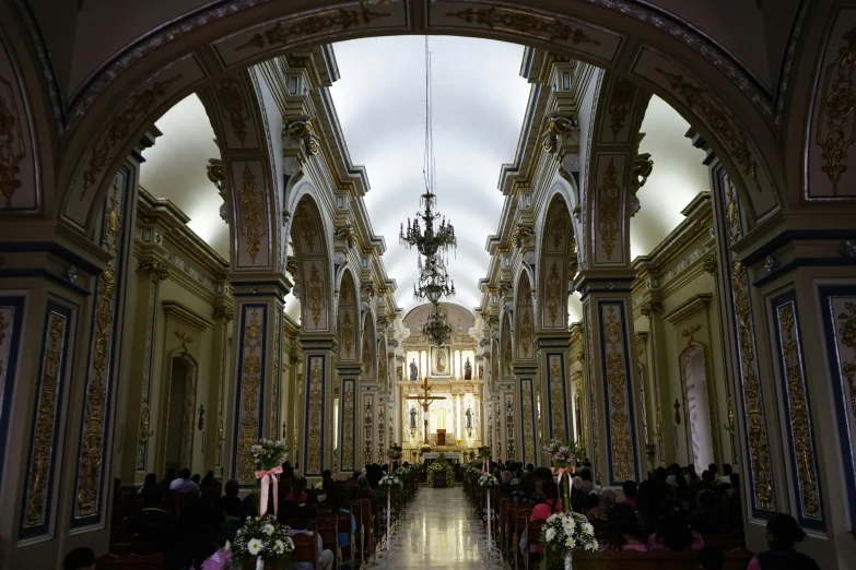 an old church with people sitting and standing inside