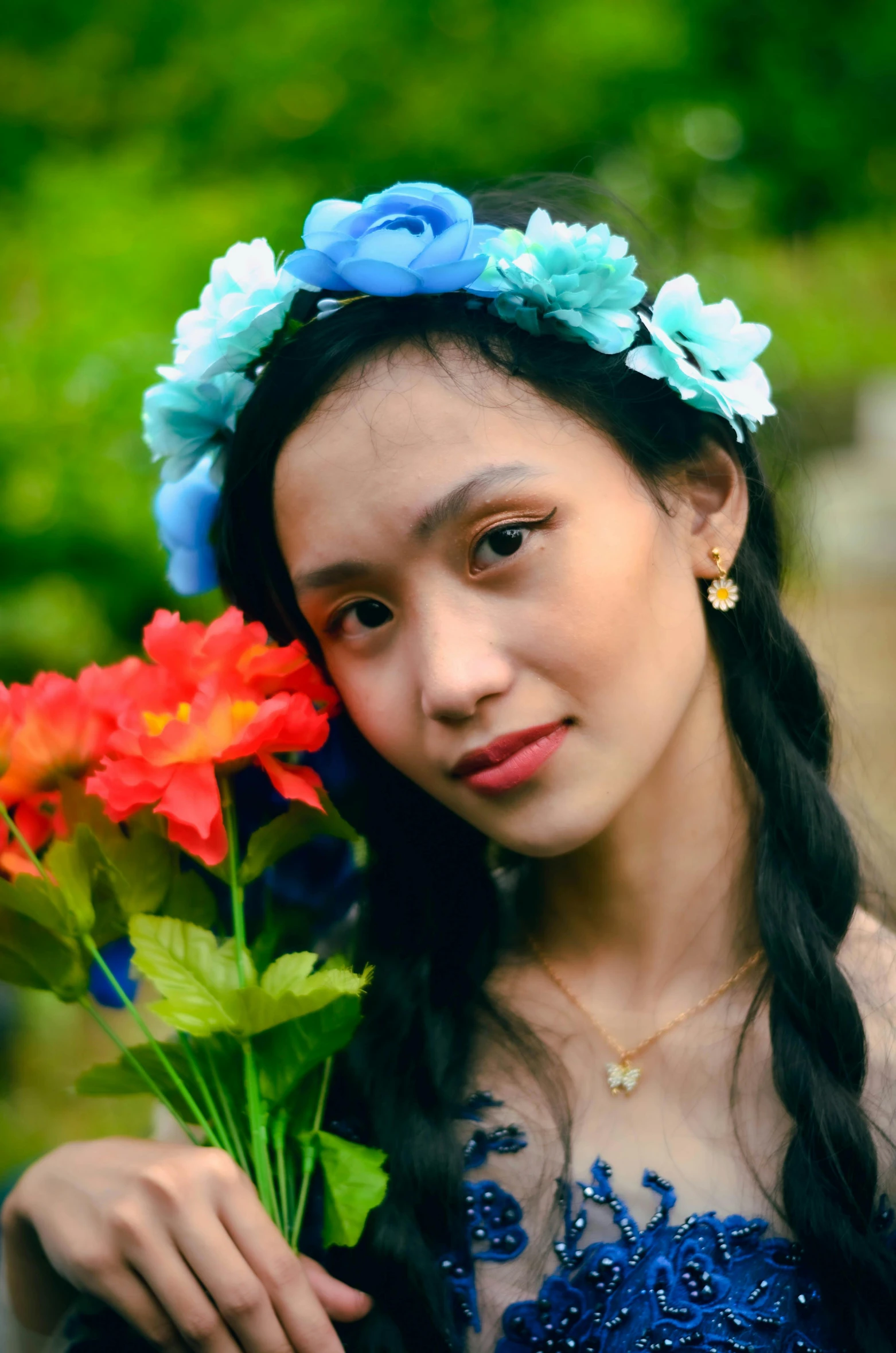 young asian woman holding colorful flowers on her head