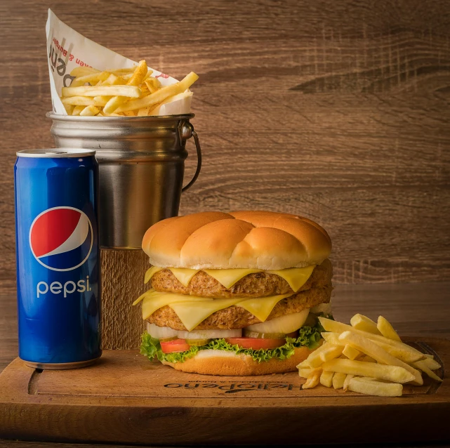 a large cheeseburger with fries and a soda