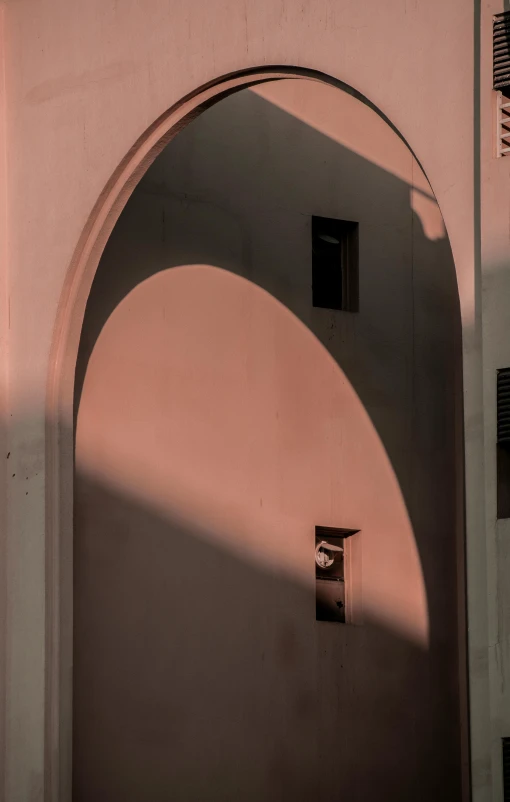 the shadows of a light over an archway