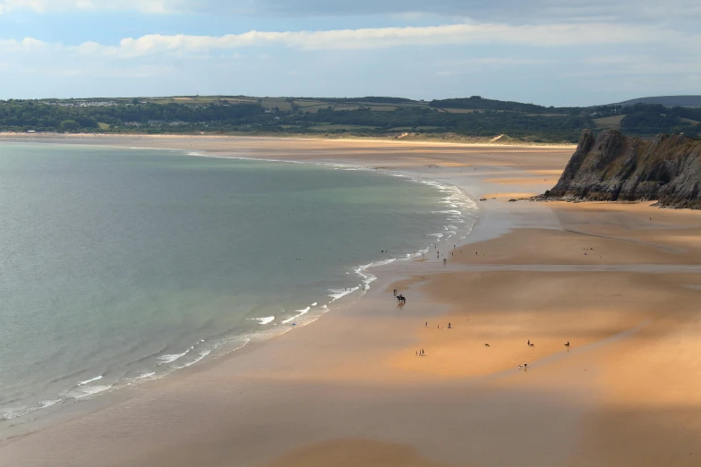 people are on a beach near the ocean