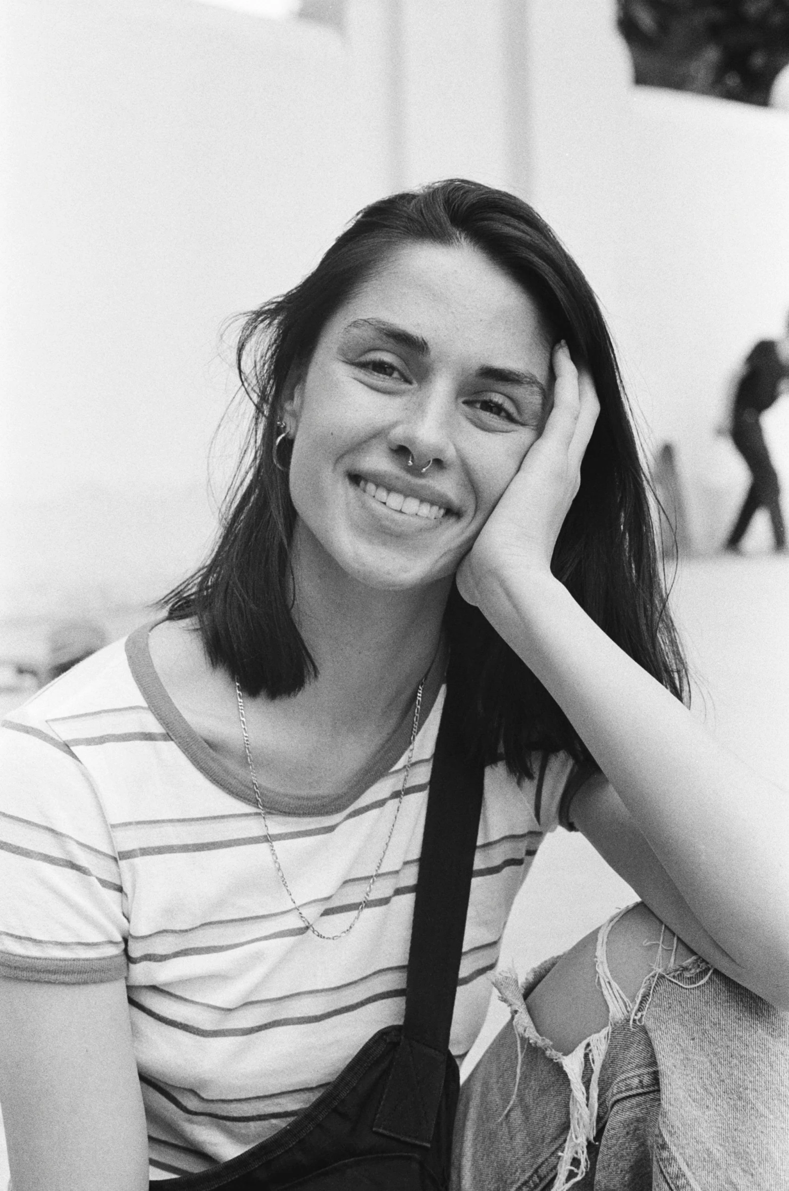 a  posing for the camera with her hand in her hair