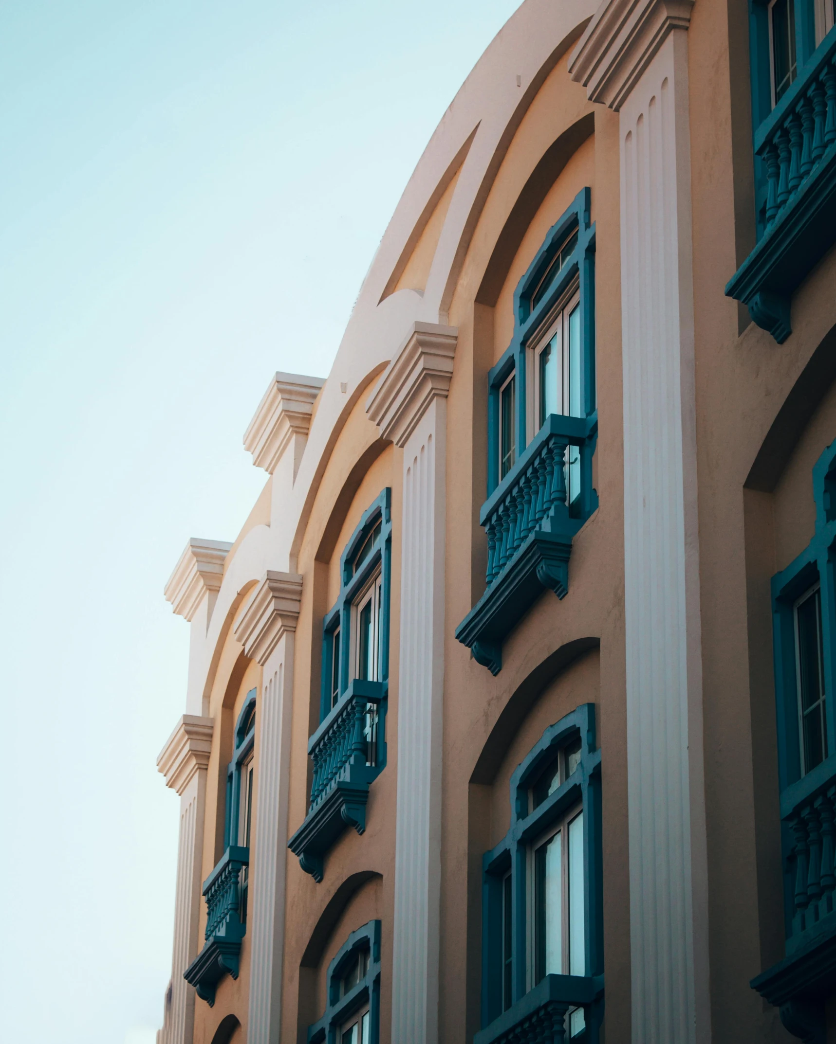 some brown building with green balconies and windows